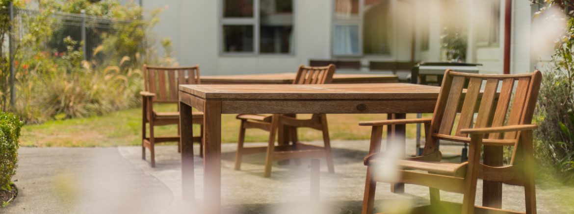 Te Hopai Home and Hospital outdoor patio area with wood furniture